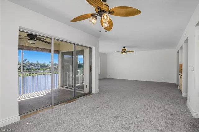 a view of a livingroom with furniture and chandelier fan