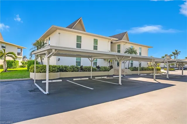a view of a patio with a table and chairs under an umbrella