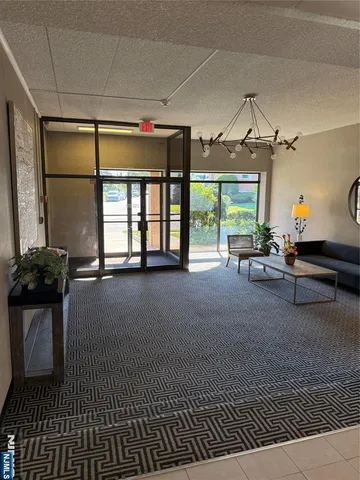 a living room with furniture a window and a chandelier