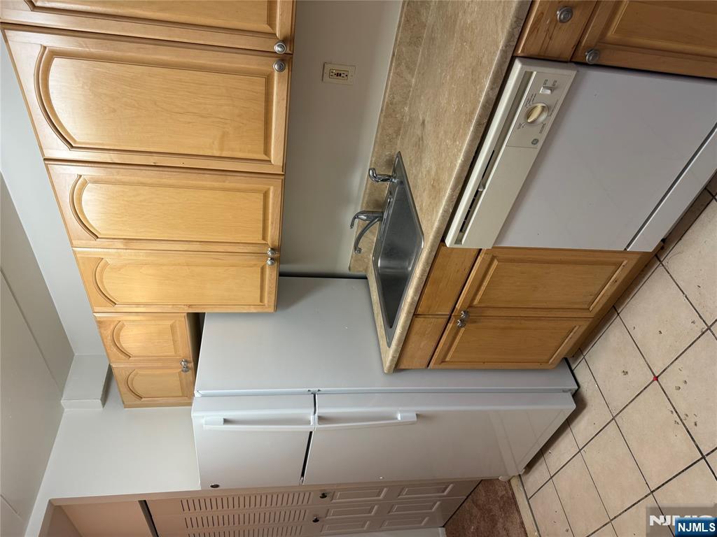 873 Main Street, Unit 2C Hackensack, NJ 07601 - Photo 4 of 11 a kitchen with stainless steel appliances granite countertop a refrigerator and a sink