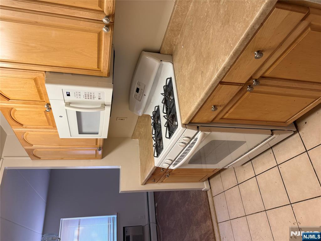 873 Main Street, Unit 2C Hackensack, NJ 07601 - Photo 5 of 11 a kitchen with a stove and a microwave