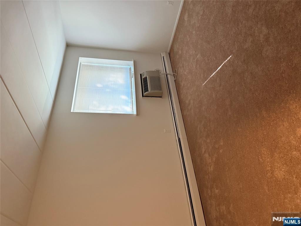 873 Main Street, Unit 2C Hackensack, NJ 07601 - Photo 6 of 11 a view of an empty room with a window