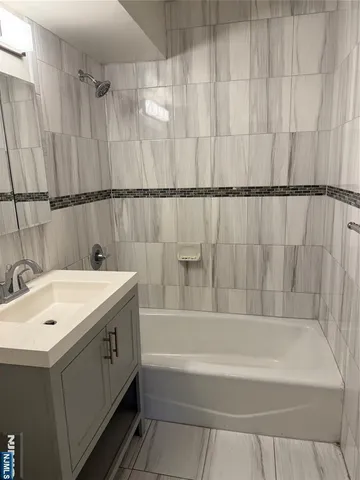 a bathroom with a bathtub and shower