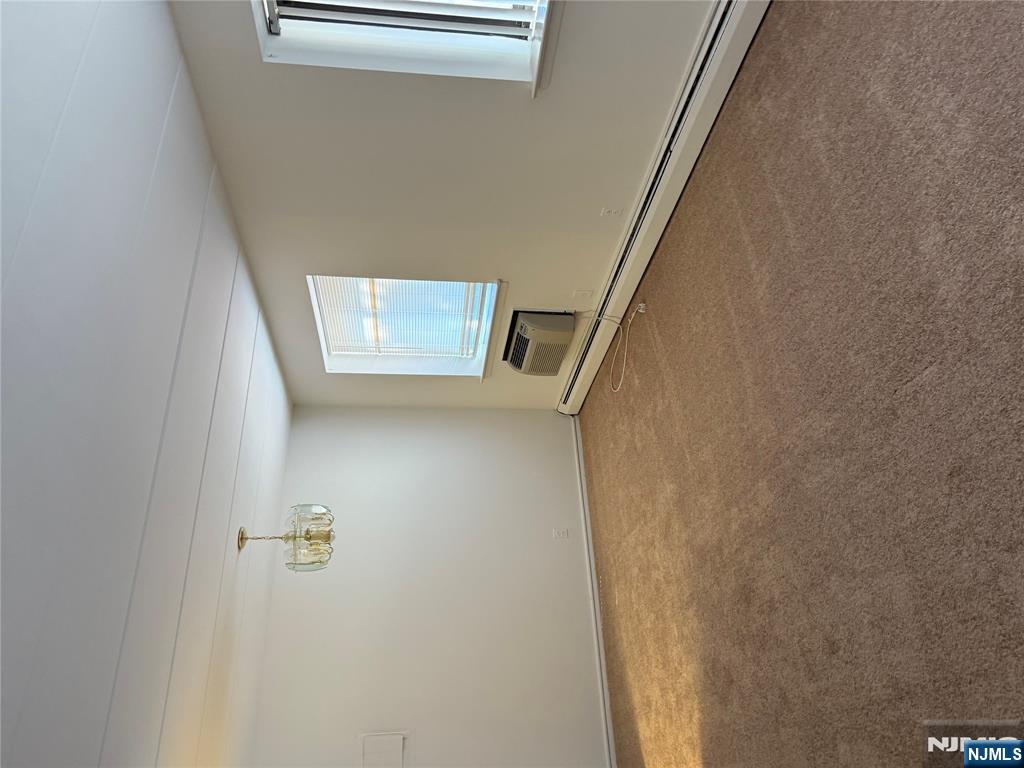 873 Main Street, Unit 2C Hackensack, NJ 07601 - Photo 9 of 11 an empty room with windows