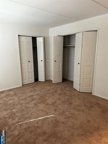 a view of an empty room with closet area