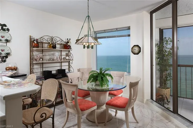 a view of a dining room with furniture window and outside view