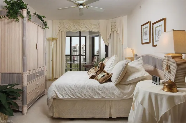 a bedroom with two beds and a large window