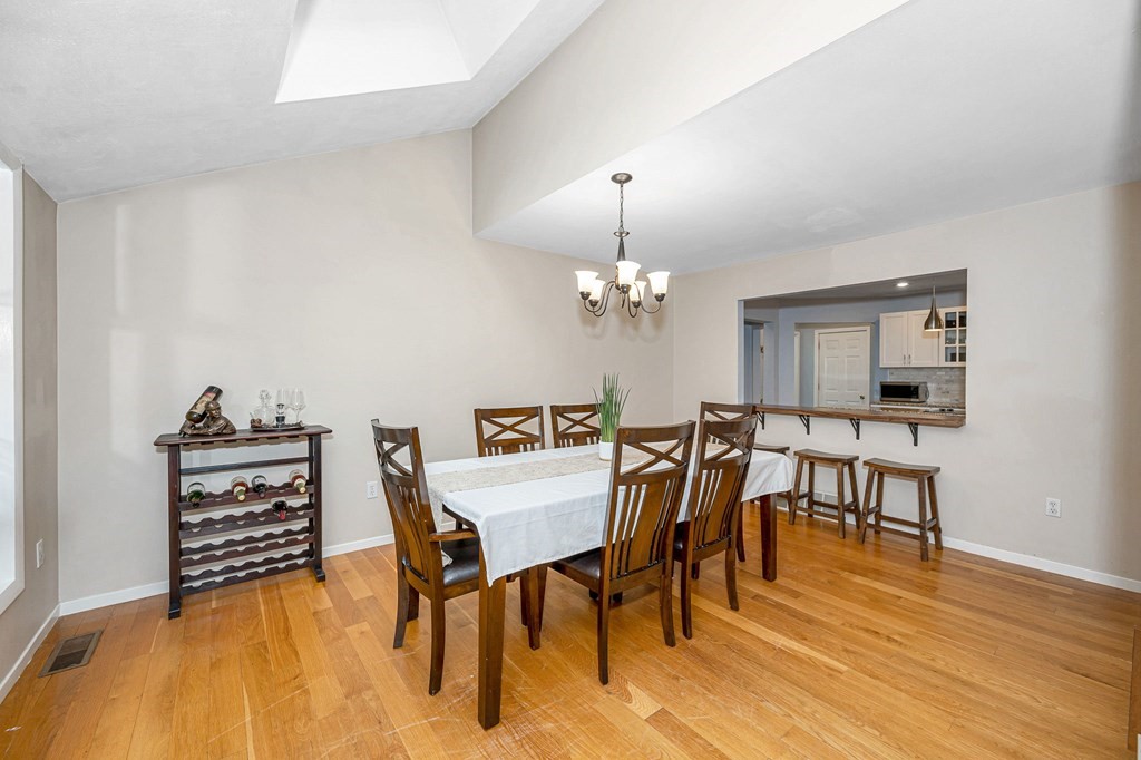 18 Fairview Farm Road Haverhill, MA 01832 - Photo 11 of 42 a view of a dining room with furniture and wooden floor