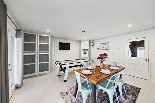 a bedroom with a bed a dresser and wooden floor