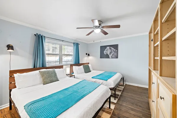 a bedroom with a bed and wooden floor