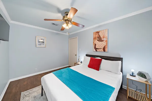 a bedroom with a bed and a flat screen tv