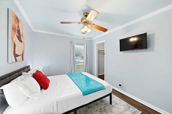 a bedroom with a bed and a large window