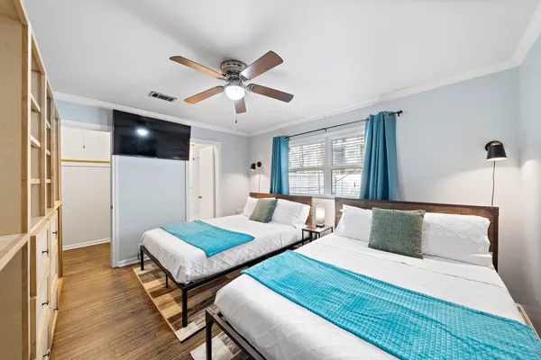 a bedroom with a bed and a wooden floor