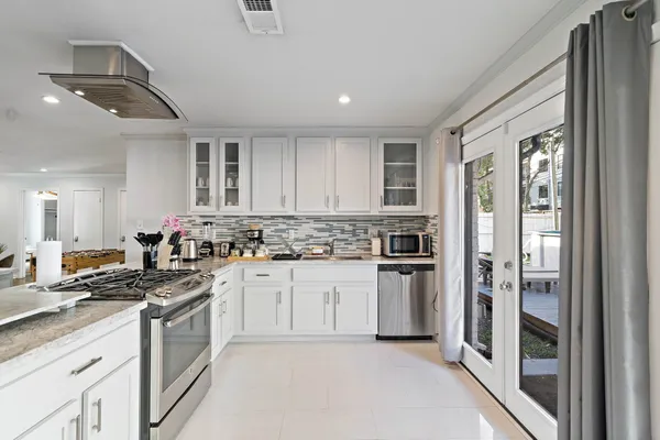 a kitchen with a refrigerator stove top oven and sink