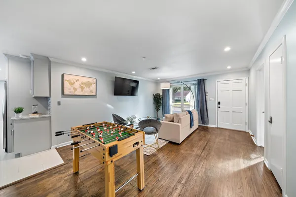 a living room with furniture and a wooden floor