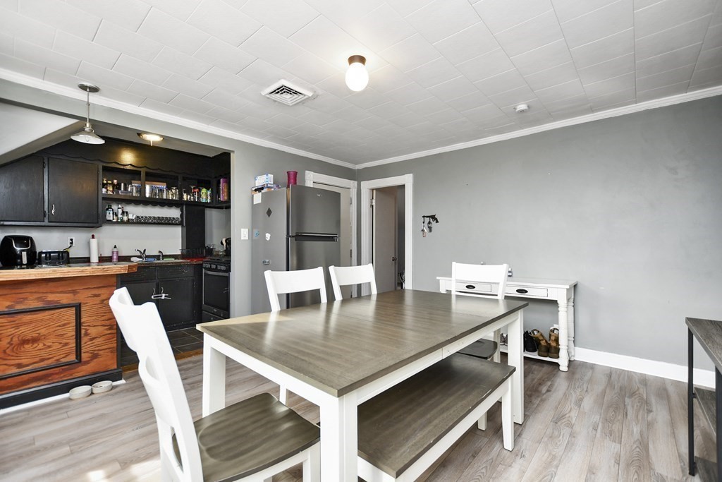 29 Foster Street Fall River, MA 02721 - Photo 16 of 38 a view of kitchen and dining room with wooden floor