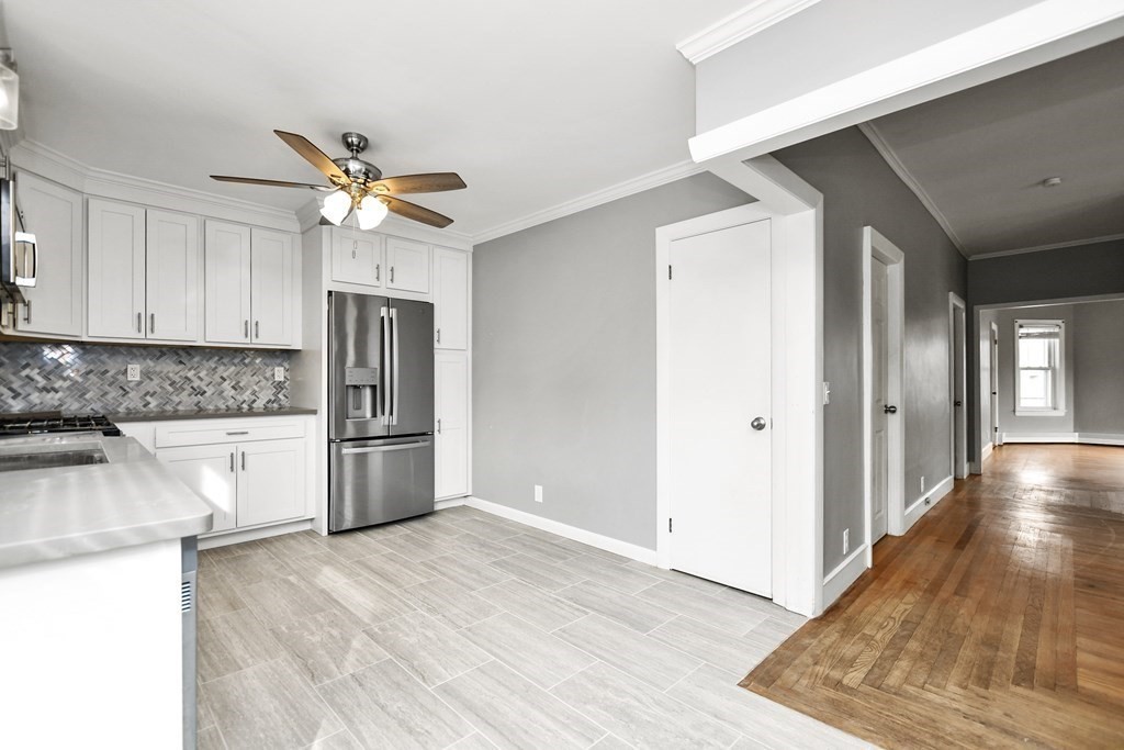 29 Foster Street Fall River, MA 02721 - Photo 3 of 38 a view of a kitchen with a sink and a refrigerator