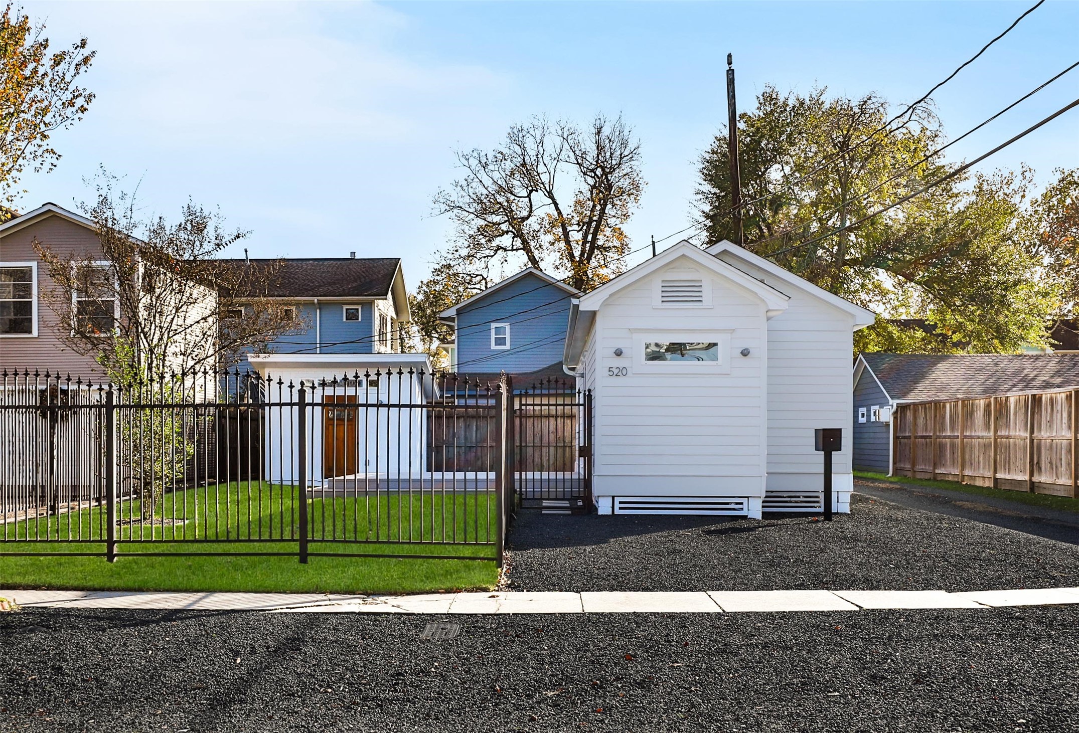 a front view of a house with a garden and plants