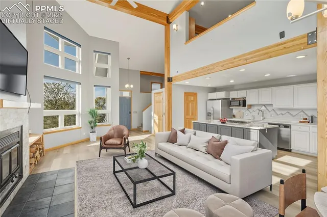 a living room with fireplace furniture and a flat screen tv