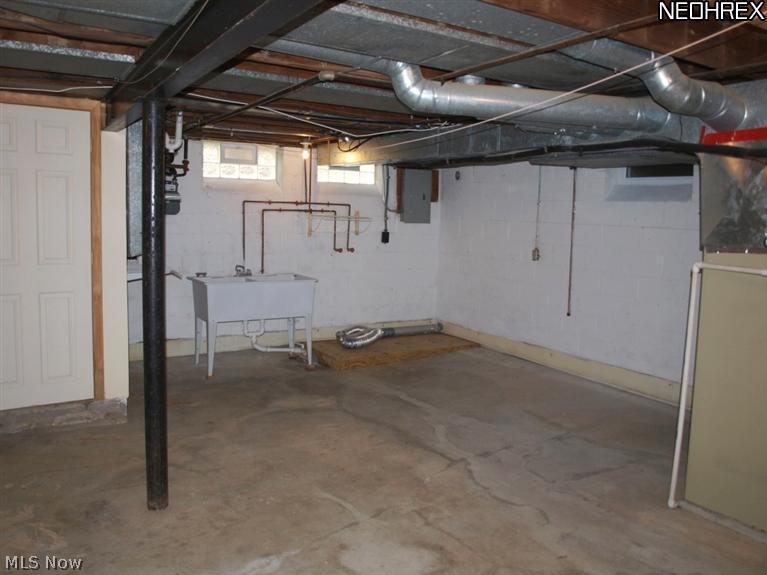 1577 Wood Road Cleveland, OH 44121 - Photo 20 of 25 Unfinished basement with 1/2 bath, glass block windows, newer furnace, C/A and Water tank