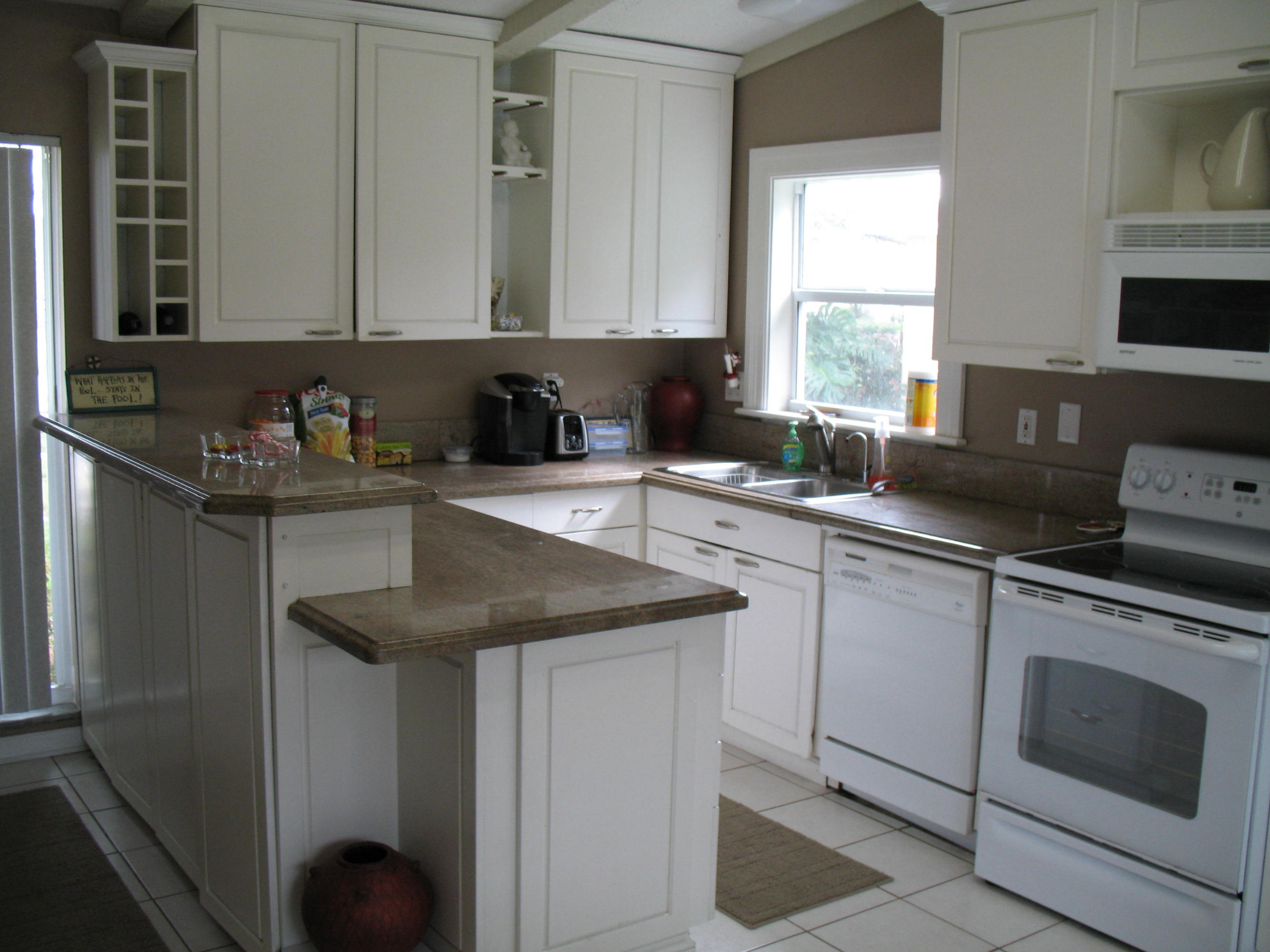 10213 Sleepy Brook Way Boca Raton, FL 33428 - Photo 6 of 15 a kitchen with granite countertop a sink a stove and cabinets