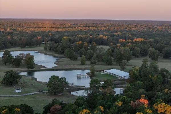 an aerial view of a house with outdoor space and lake view