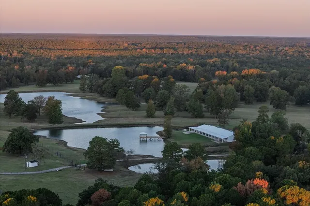 an aerial view of a house with outdoor space and lake view