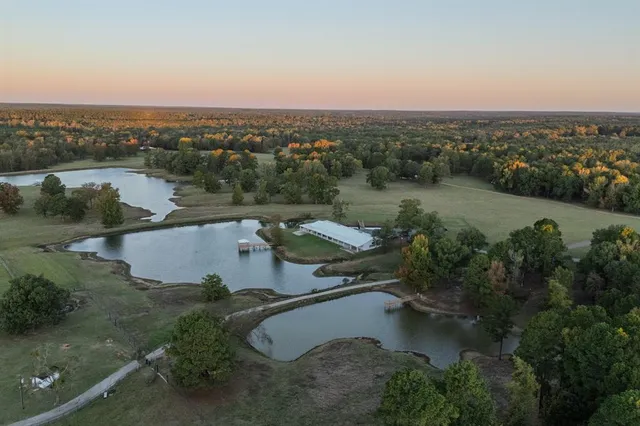 a backyard of a house with a yard and outdoor seating