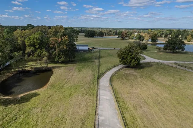 an aerial view of a house with pool table and chairs