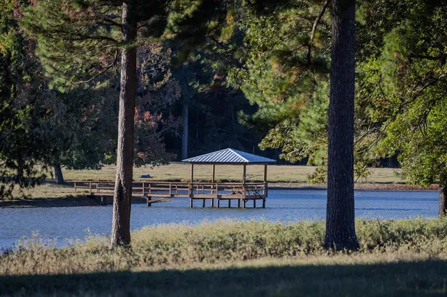 a table and chairs with wooden fence