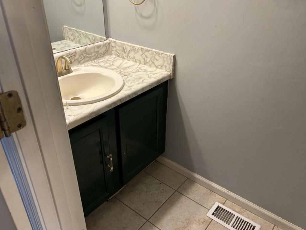 4749 Shallow Ridge Road Northeast Kennesaw, GA 30144 - Photo 13 of 28 a bathroom with a granite countertop sink and a mirror