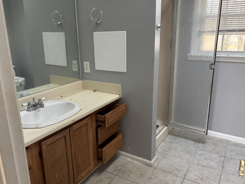 4749 Shallow Ridge Road Northeast Kennesaw, GA 30144 - Photo 17 of 28 a bathroom with a sink and a mirror