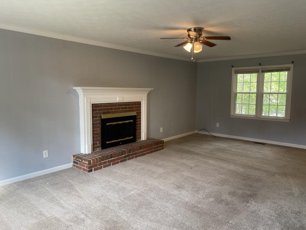 4749 Shallow Ridge Road Northeast Kennesaw, GA 30144 - Photo 3 of 28 a view of an empty room with a fireplace