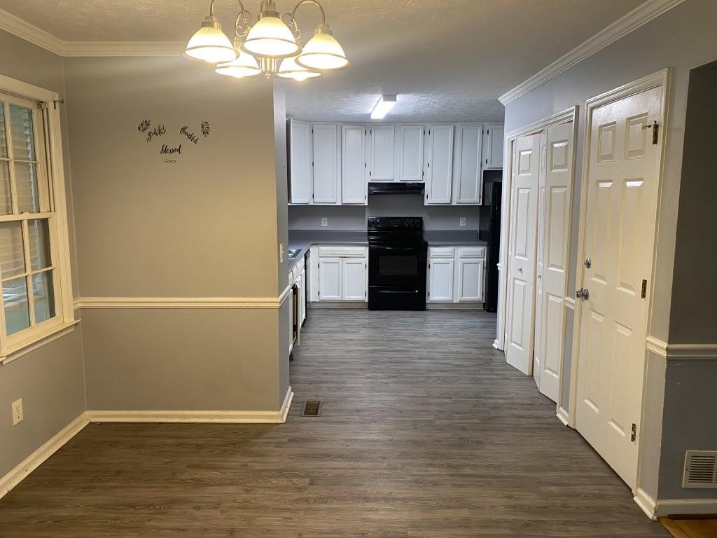 4749 Shallow Ridge Road Northeast Kennesaw, GA 30144 - Photo 6 of 28 a view of a kitchen with a refrigerator a microwave and a sink
