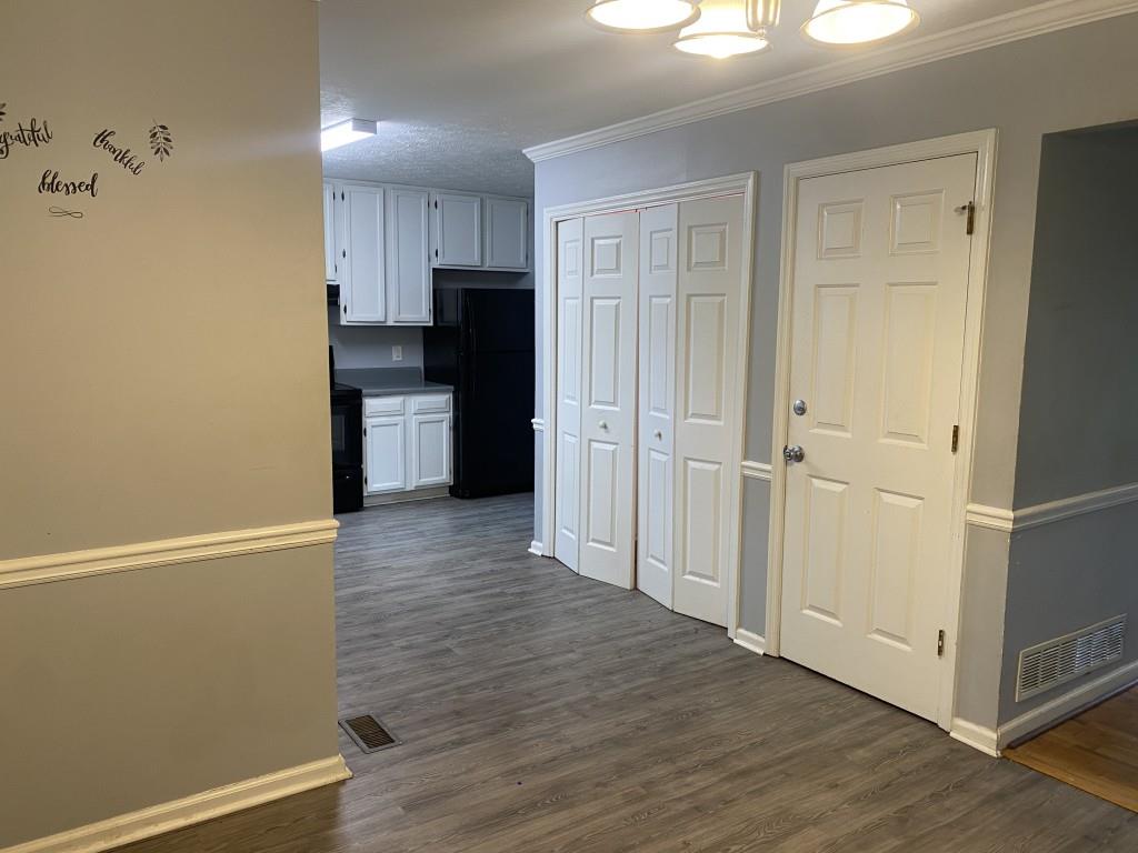 4749 Shallow Ridge Road Northeast Kennesaw, GA 30144 - Photo 7 of 28 a view of a kitchen with a refrigerator a stove top oven and cabinets