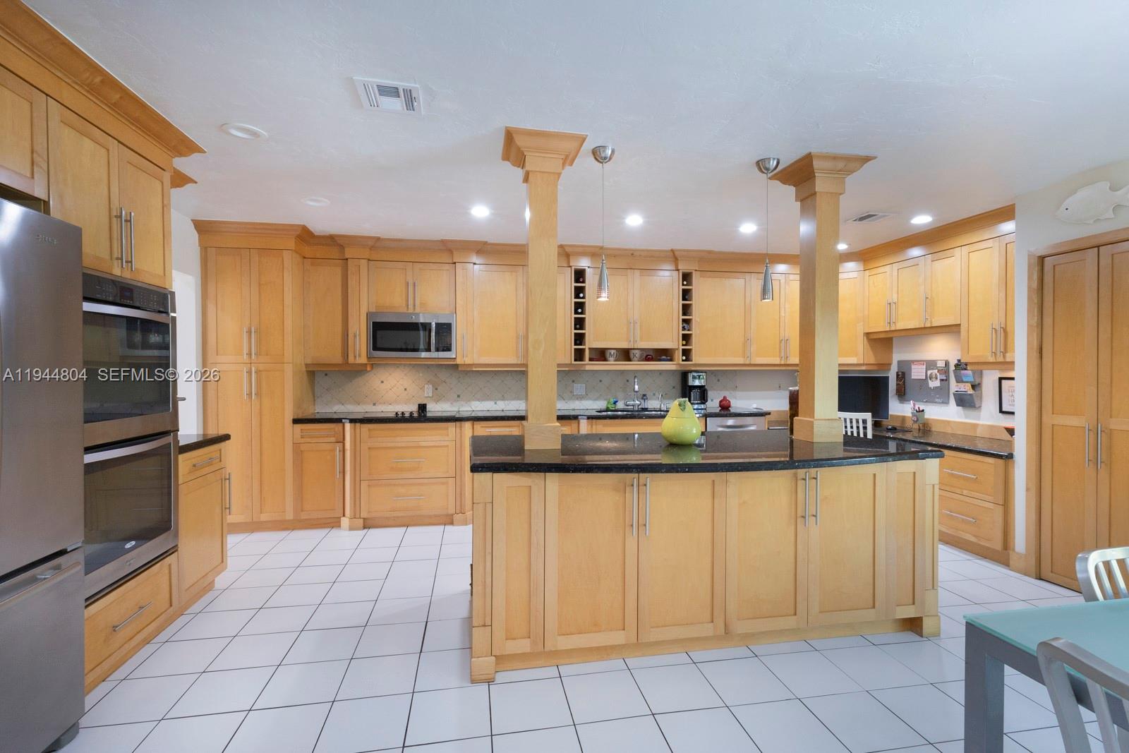 10281 Southwest 125th Street Miami, FL 33176 - Photo 13 of 45 a kitchen with granite countertop a stove a sink and a refrigerator