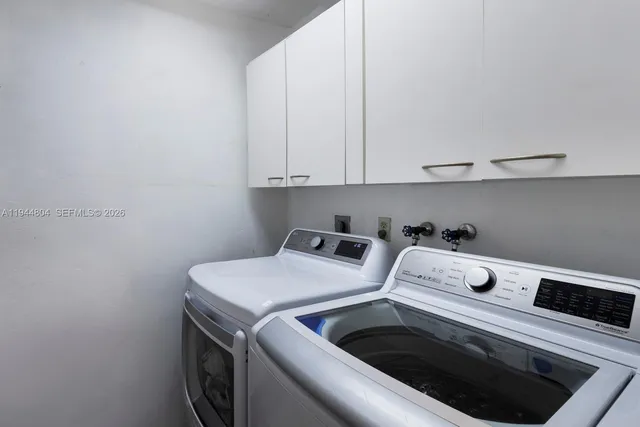 a bathroom with a granite countertop sink vanity mirror and toilet