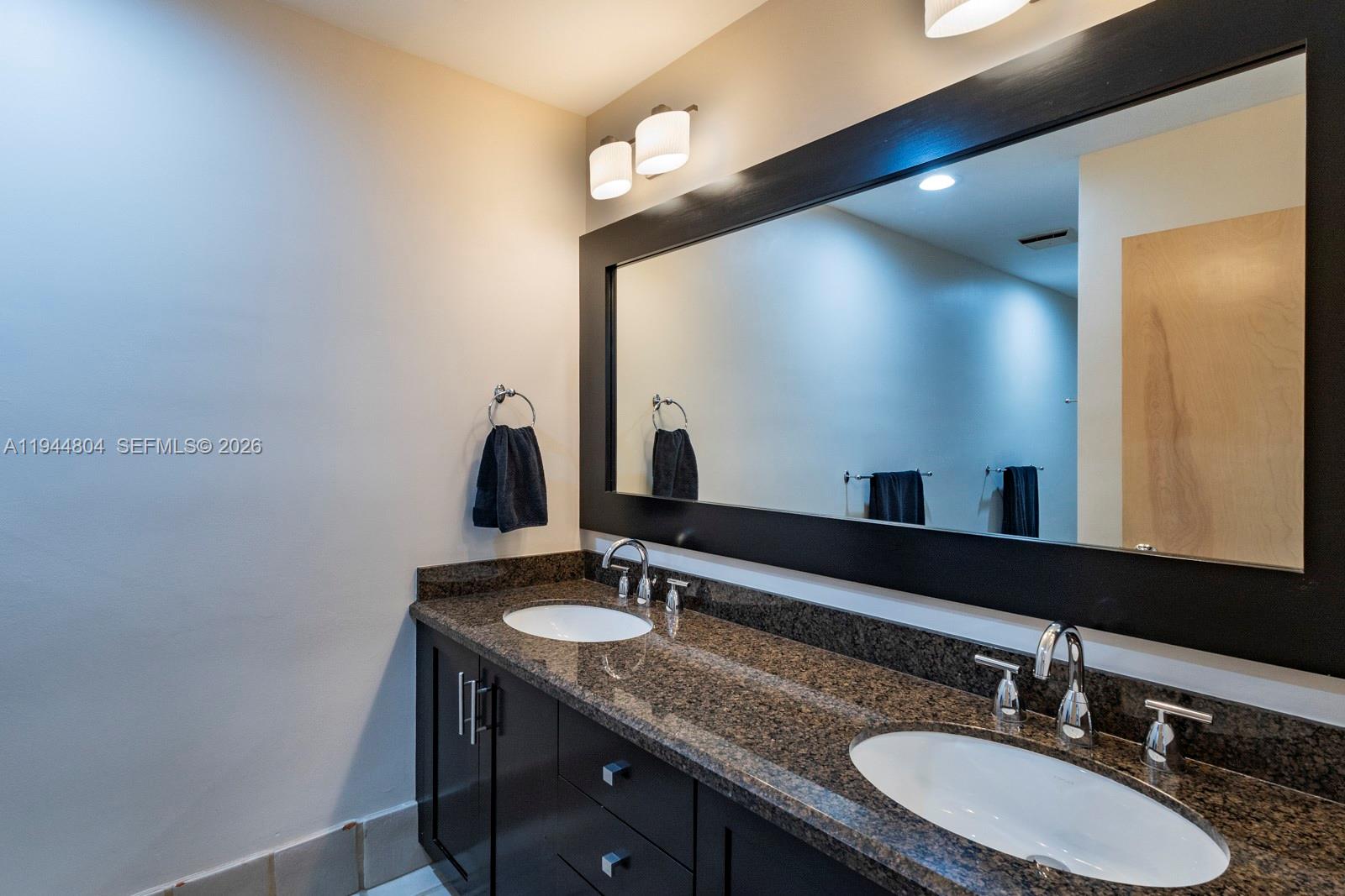 10281 Southwest 125th Street Miami, FL 33176 - Photo 32 of 45 a bathroom with a granite countertop sink and a mirror