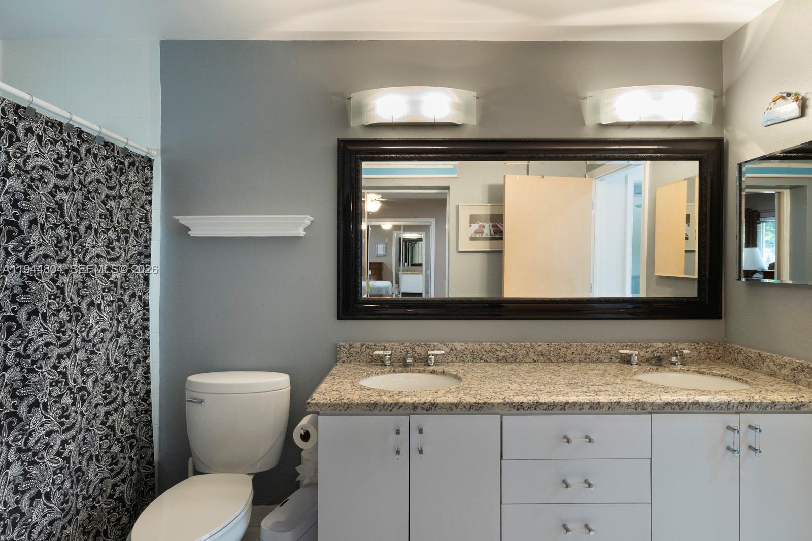 10281 Southwest 125th Street Miami, FL 33176 - Photo 35 of 45 a bathroom with a granite countertop sink vanity mirror and toilet