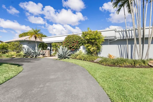a living room with furniture and view of kitchen