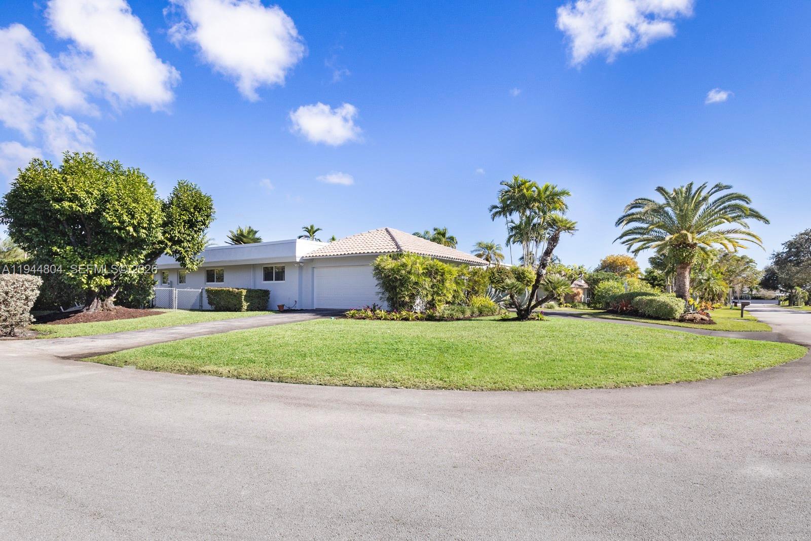 10281 Southwest 125th Street Miami, FL 33176 - Photo 41 of 45 a front view of a house with a yard and garage