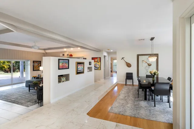 a living room with furniture a large window and a flat screen tv