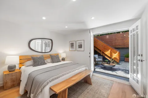 a bedroom with a bed and a potted plant