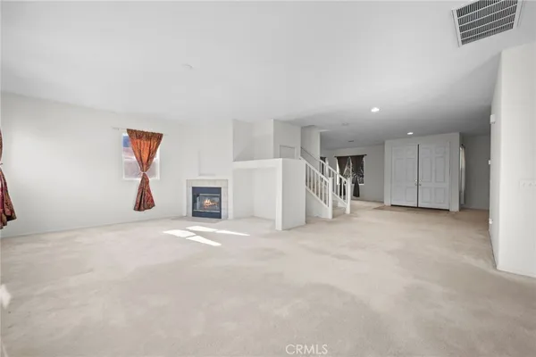 a view of an empty room with stairs