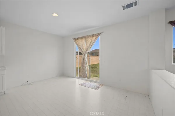 a large white kitchen with white cabinets and a sink