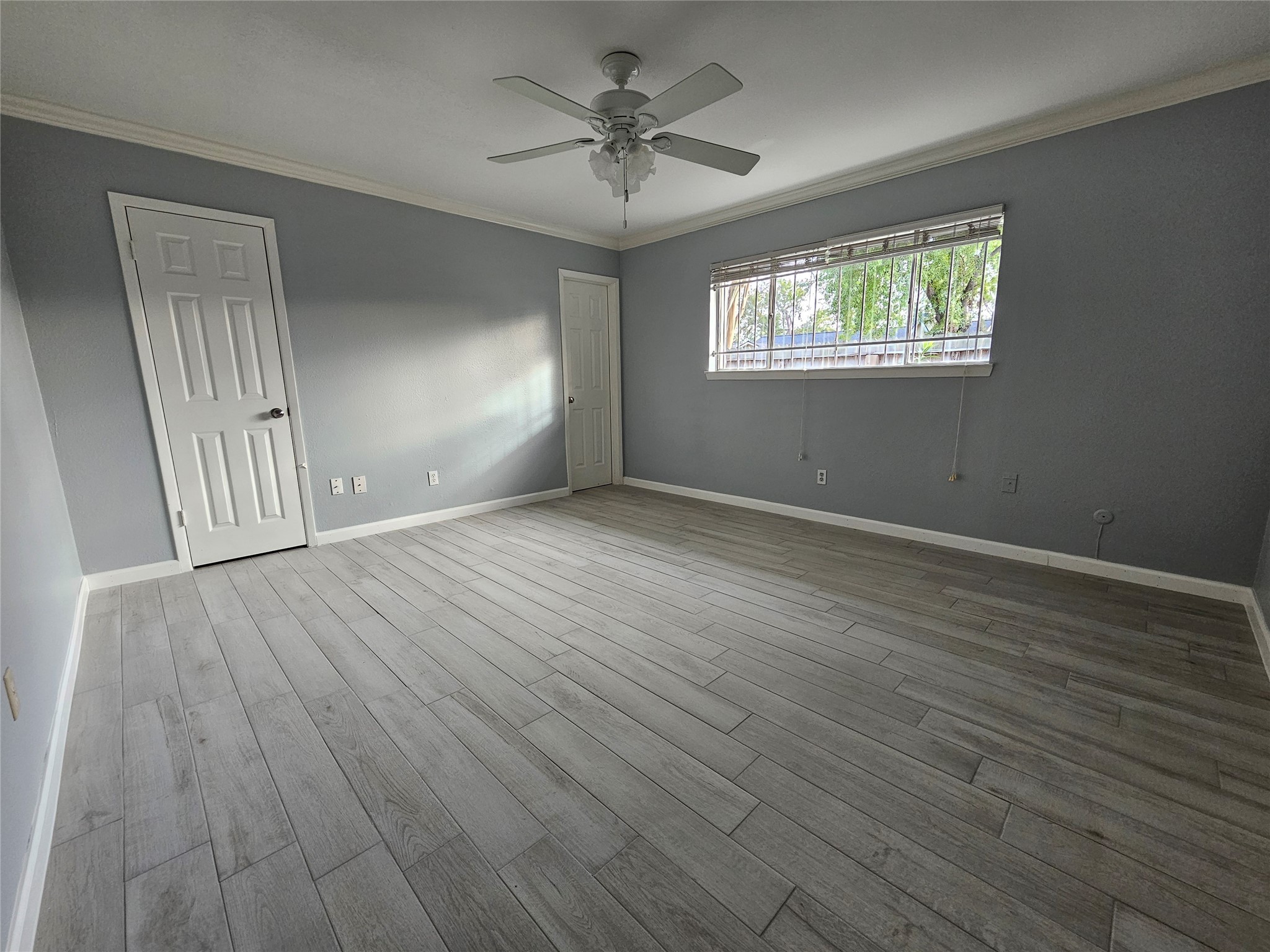 2502 Knoll Street Houston, TX 77080 - Photo 17 of 38 a view of an empty room with wooden floor and a window