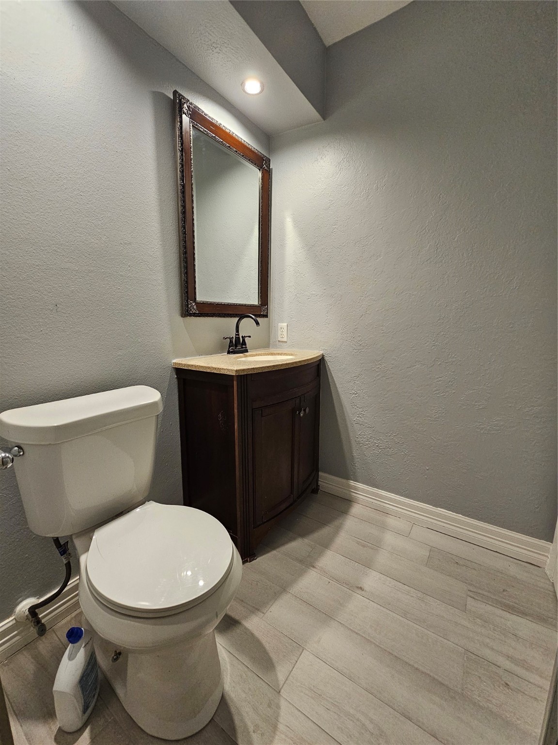 2502 Knoll Street Houston, TX 77080 - Photo 20 of 38 a bathroom with a toilet sink vanity and mirror