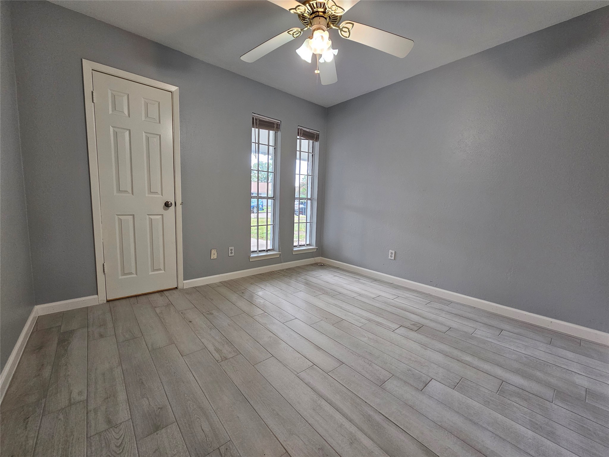 2502 Knoll Street Houston, TX 77080 - Photo 22 of 38 a view of an empty room with wooden floor and a window