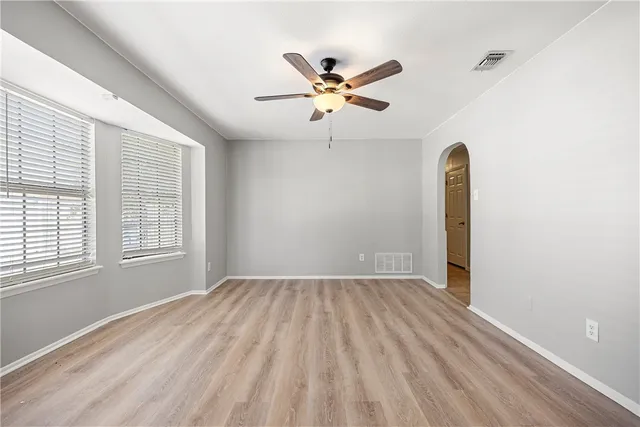 a view of a livingroom with a ceiling fan and window