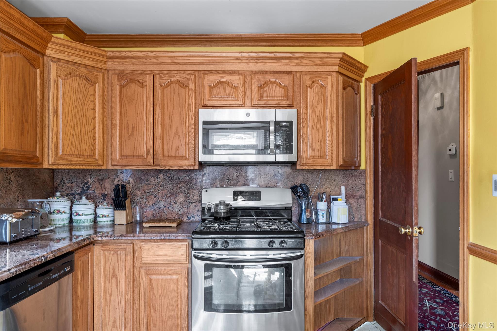 18 Butler Place Yonkers, NY 10710 - Photo 12 of 46 a kitchen with stainless steel appliances granite countertop a stove a sink and a microwave